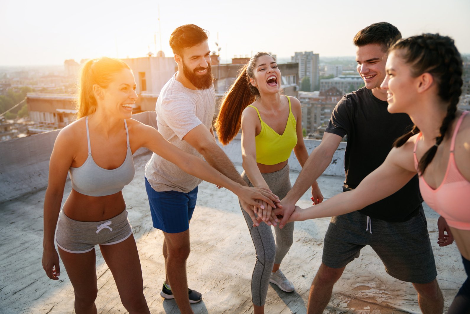 Group of fit healthy friends, people exercising together outdoor